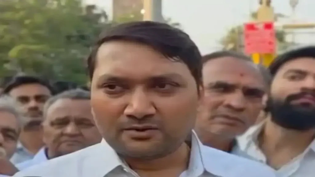 Alpesh Miyani surrounded by supporters and onlookers.