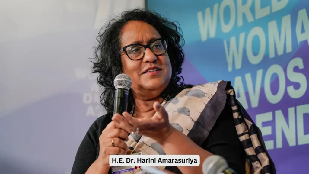 "H.E. Dr. Harini Amarasuriya, Prime Minister of Sri Lanka, speaking passionately into a microphone at a global women's leadership summit."